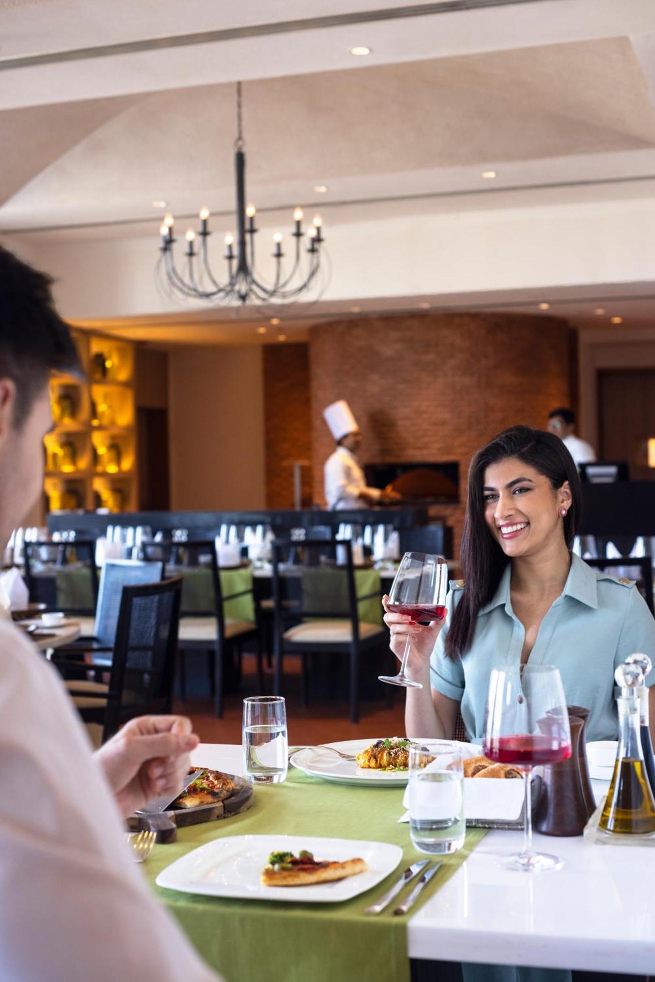 Trident Hyderabad Hotel Bagian luar foto A woman drinking wine